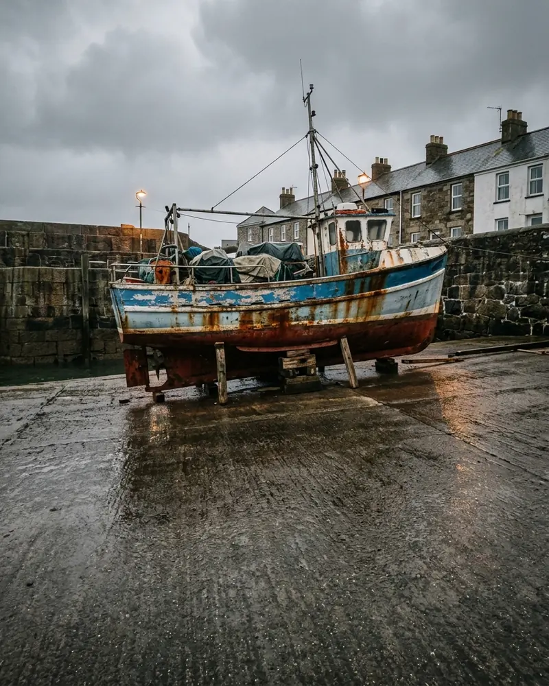 Inshore fishing boat hauled out on a harbour slipway, out of service