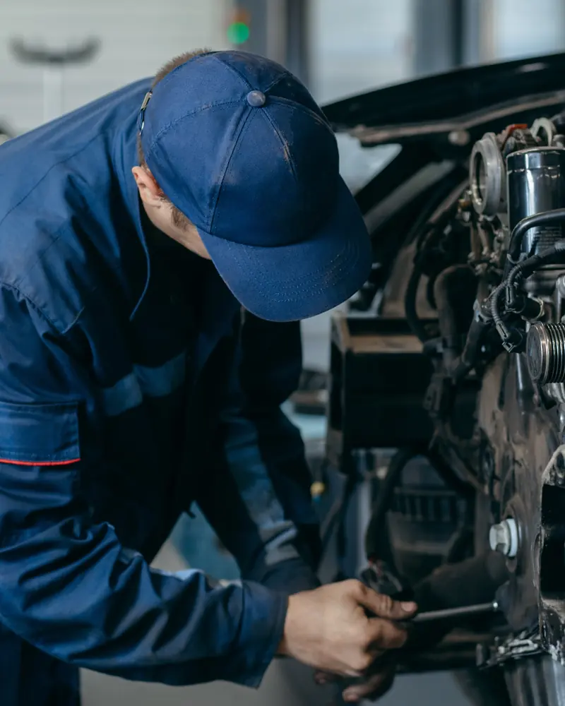 Engineer inspecting a used diesel engine before sale